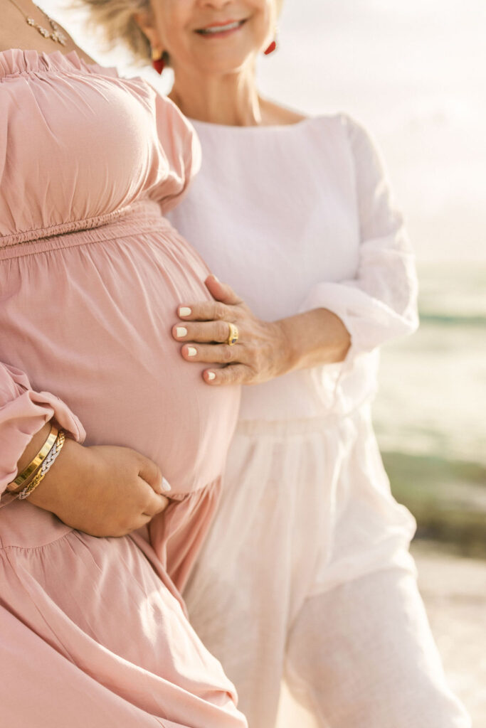 Multi-generational maternity beach session with mother and grandmother in Miami.