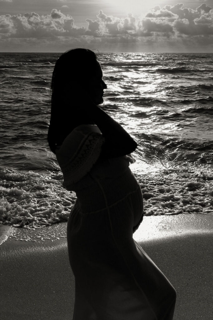 Silhouette maternity portrait by the ocean during a Miami beach session.