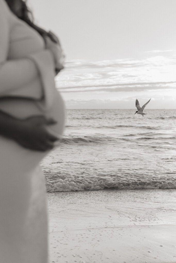 Fine art maternity photography detail with ocean waves in South Florida.