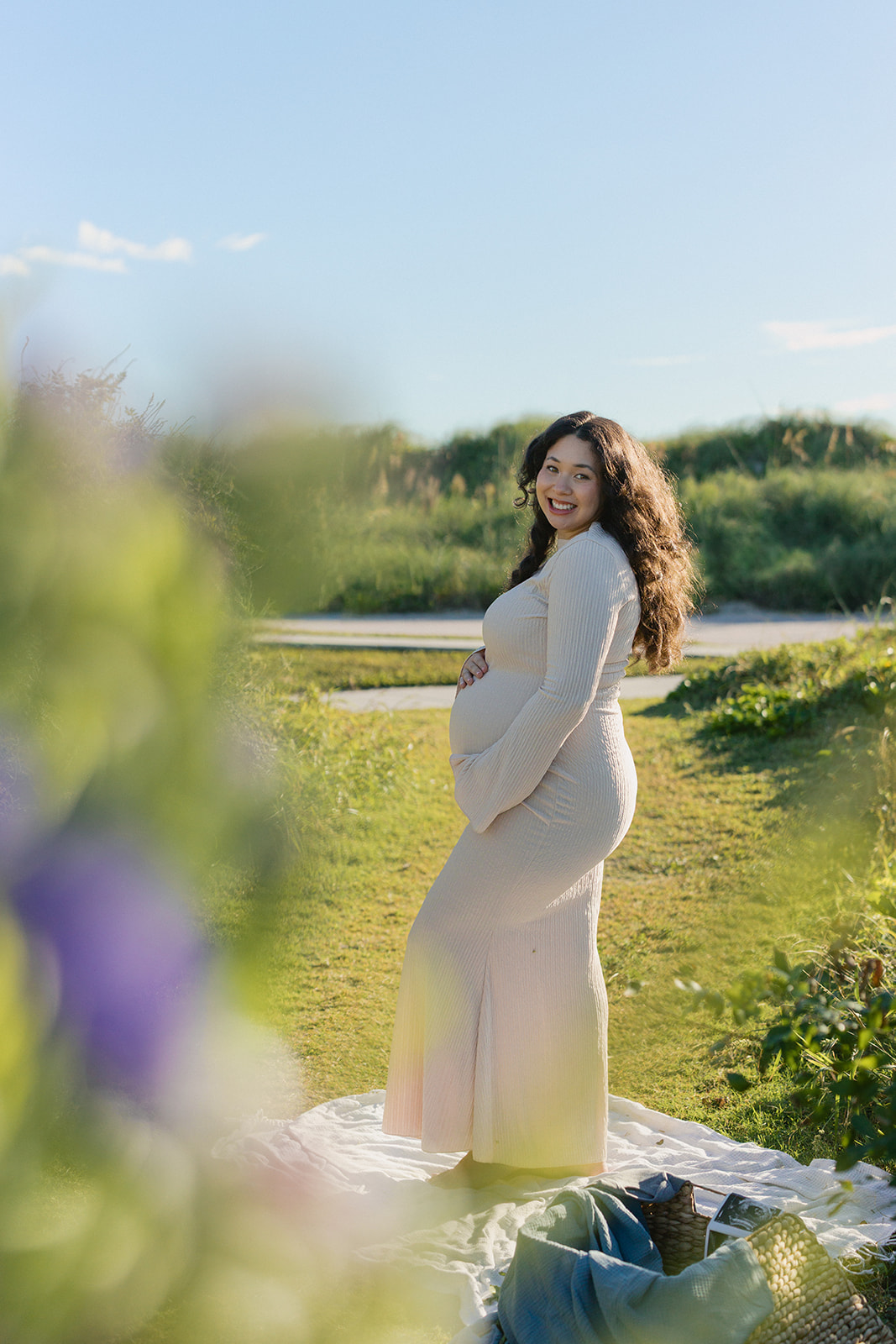 Expecting mother standing in a field during a South Florida maternity photography session.